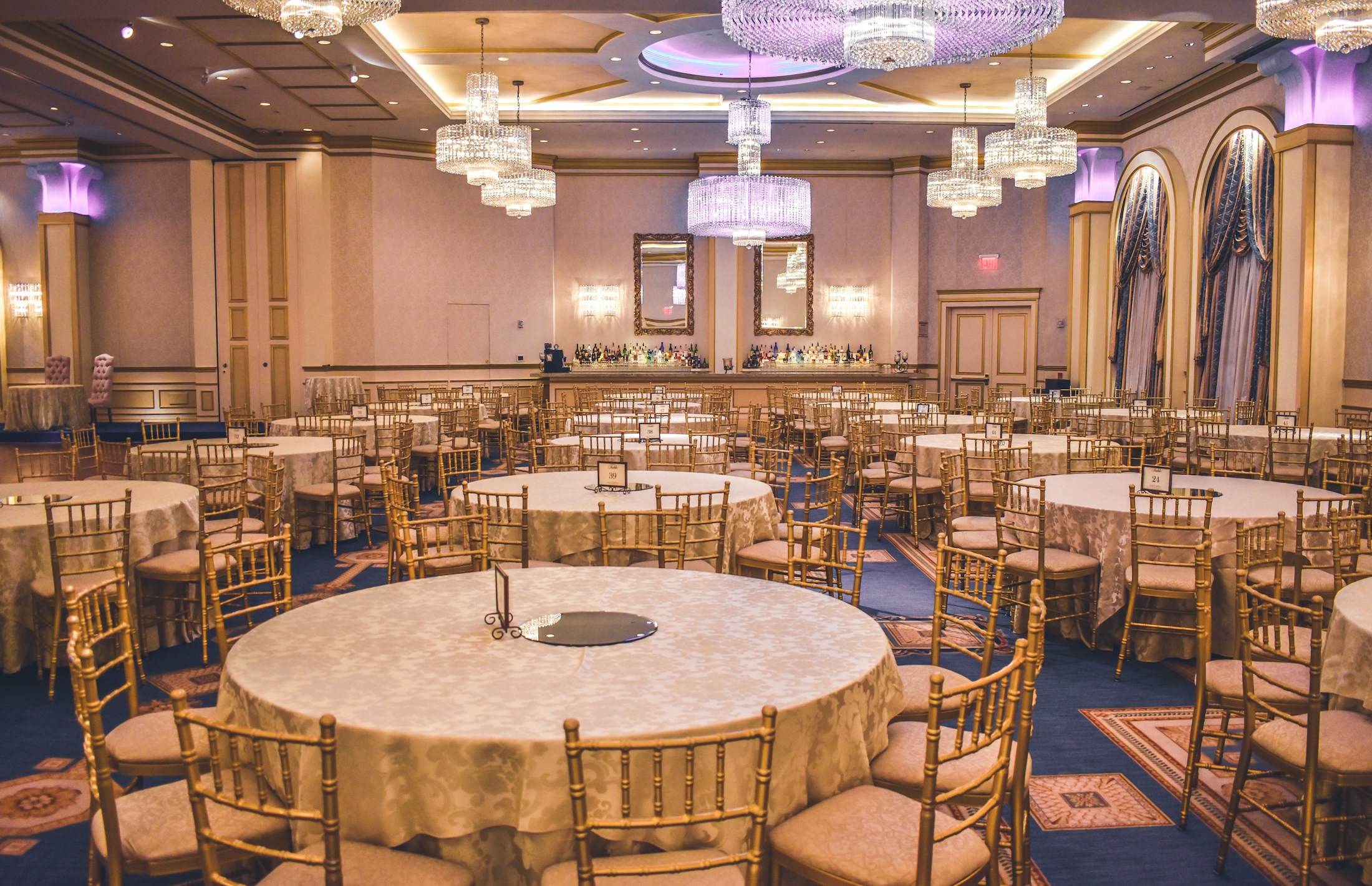 Styling inspiration: an elegant ballroom with chandeliers and gold-toned seating